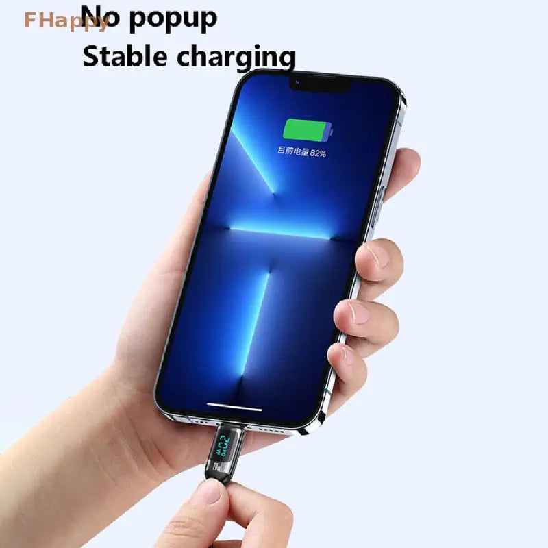 a hand holding a cell phone with a charging cable