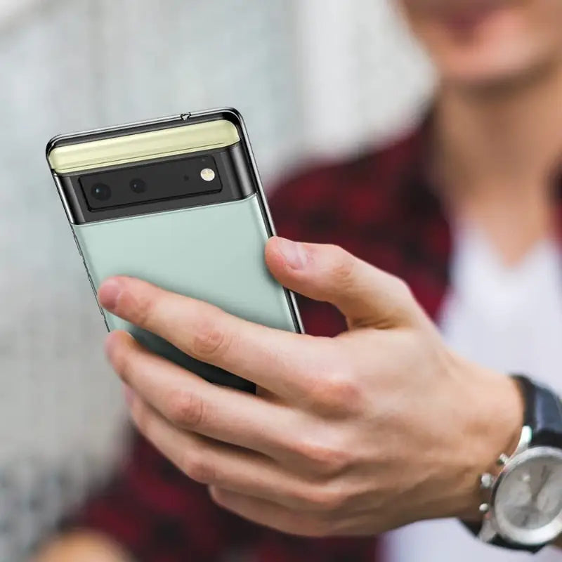 a man holding a cell phone in his hand