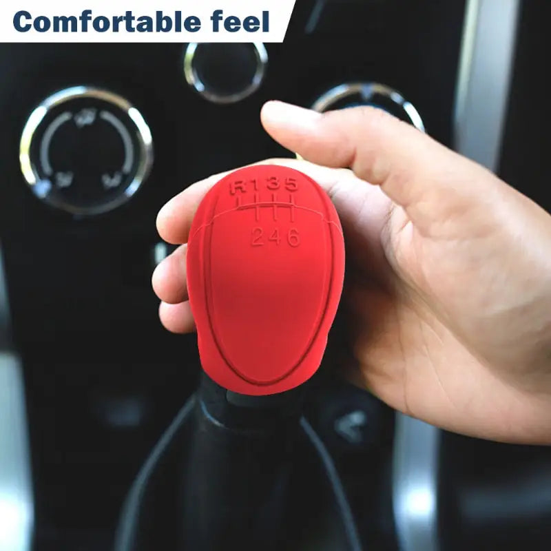 a hand holding a red car key in a car
