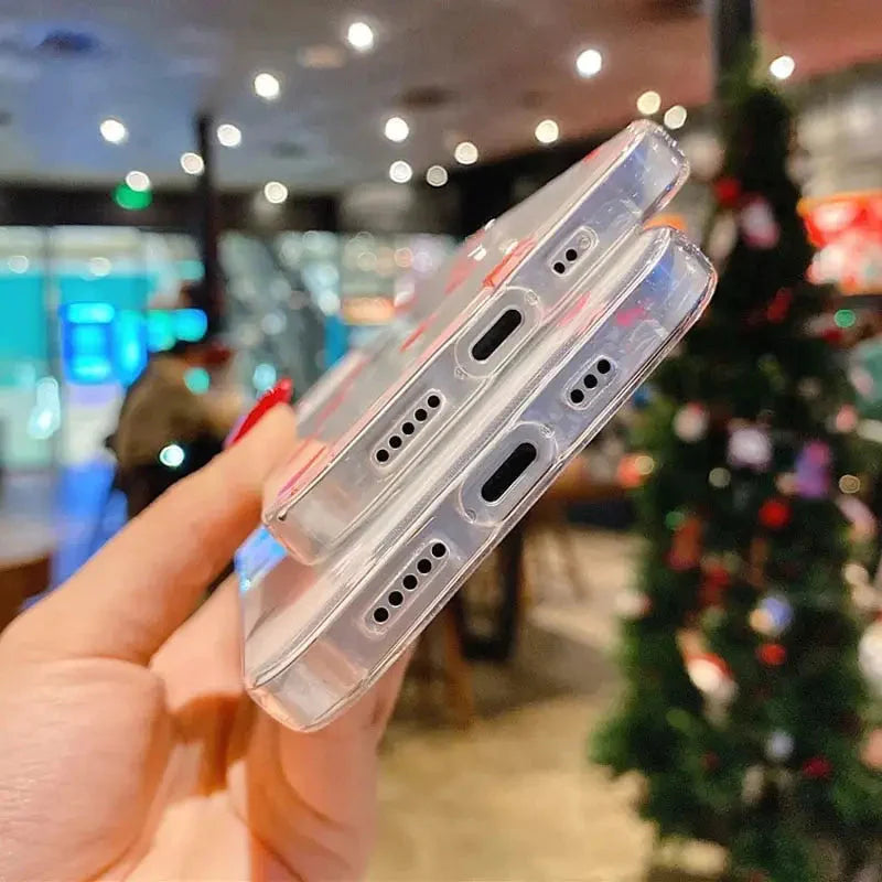a hand holding a clear case with a christmas tree in the background