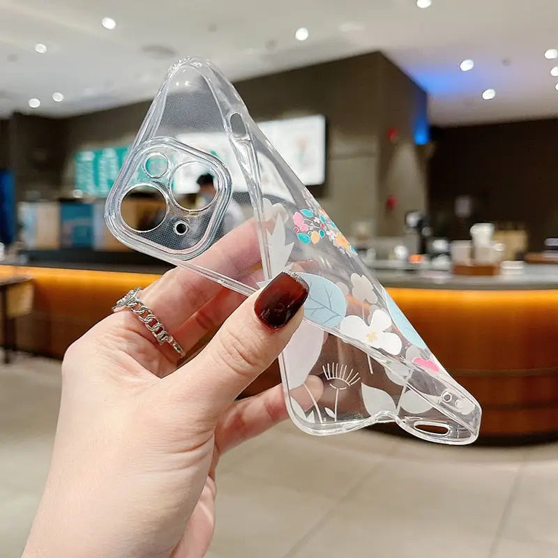 a hand holding a clear plastic case with a colorful design