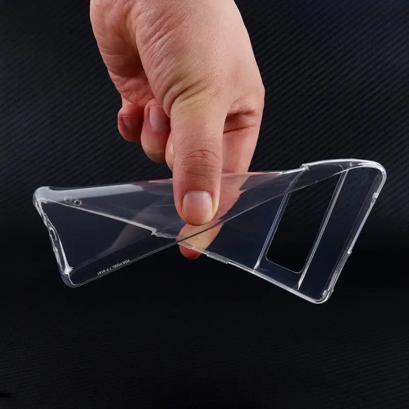 a hand holding a clear plastic case