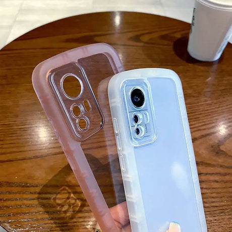 a hand holding a clear case with a phone in it