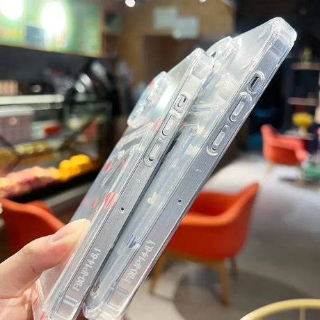 a hand holding a clear plastic case