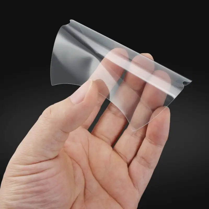 a hand holding a clear plastic sheet