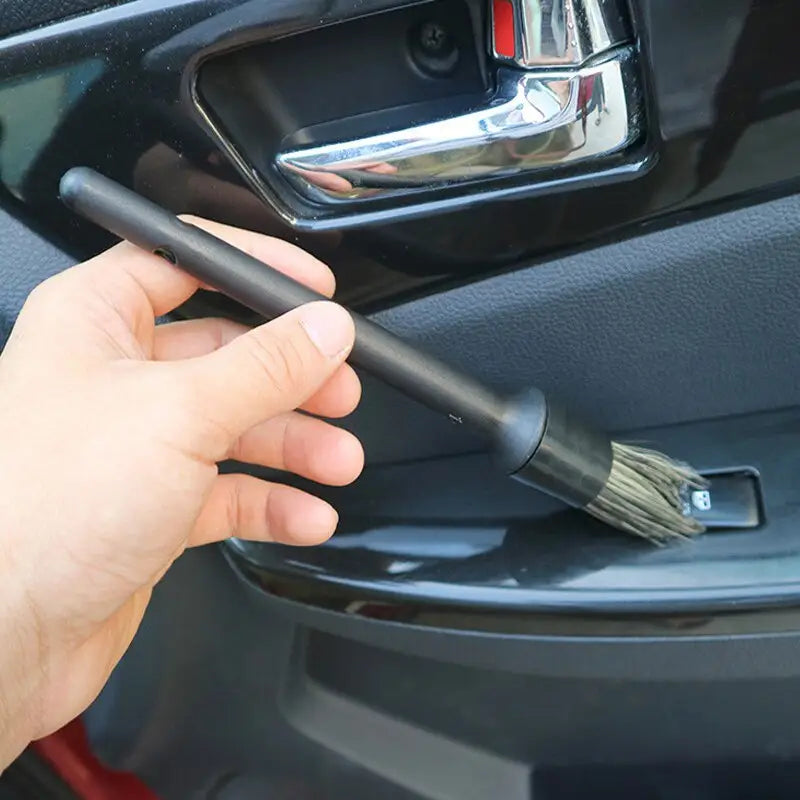 a hand holding a car door handle