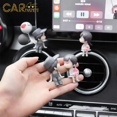 someone is holding a toy in their hand in a car