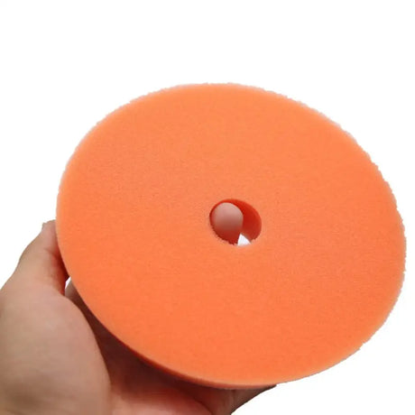 a hand holding a foam pad