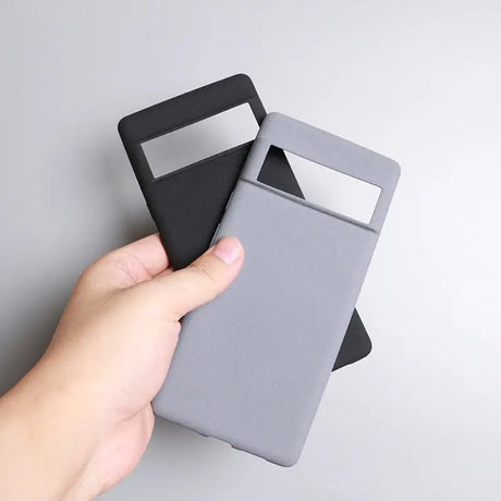 a hand holding a gray and black card case