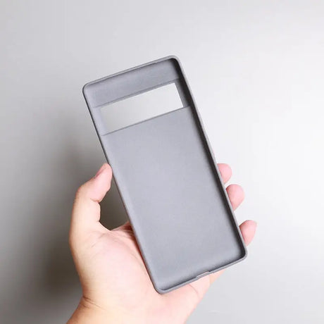 a hand holding a gray card case