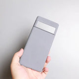 a hand holding a gray card case