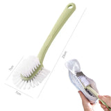a hand holding a green brush and a white brush