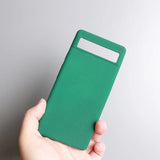 a hand holding a green card case