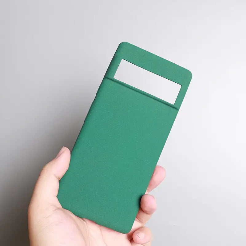 a hand holding a green card case