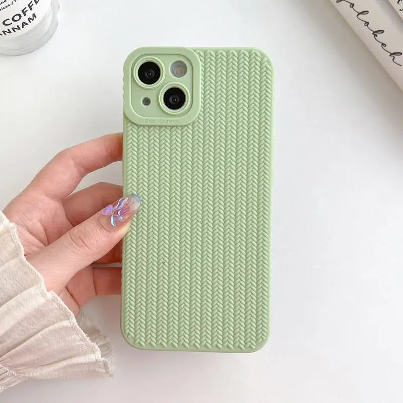 a hand holding a green iphone case