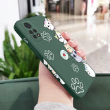a hand holding a green phone case with a cartoon character design