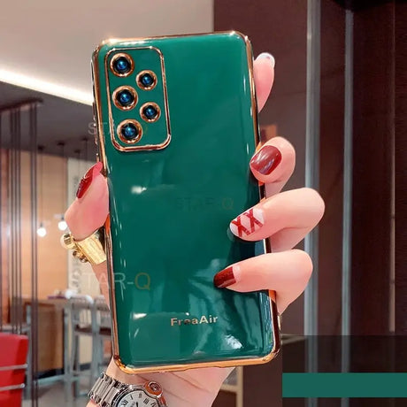 someone holding a green phone with a gold ring on it