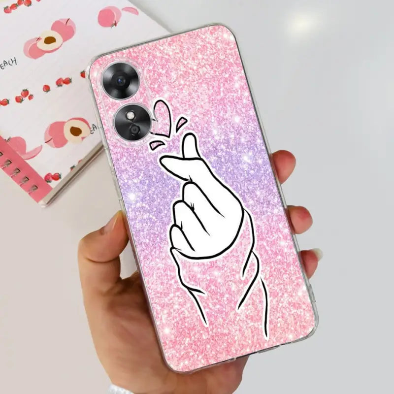 a hand holding a phone case with pink glitter