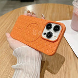 a hand holding an orange phone case