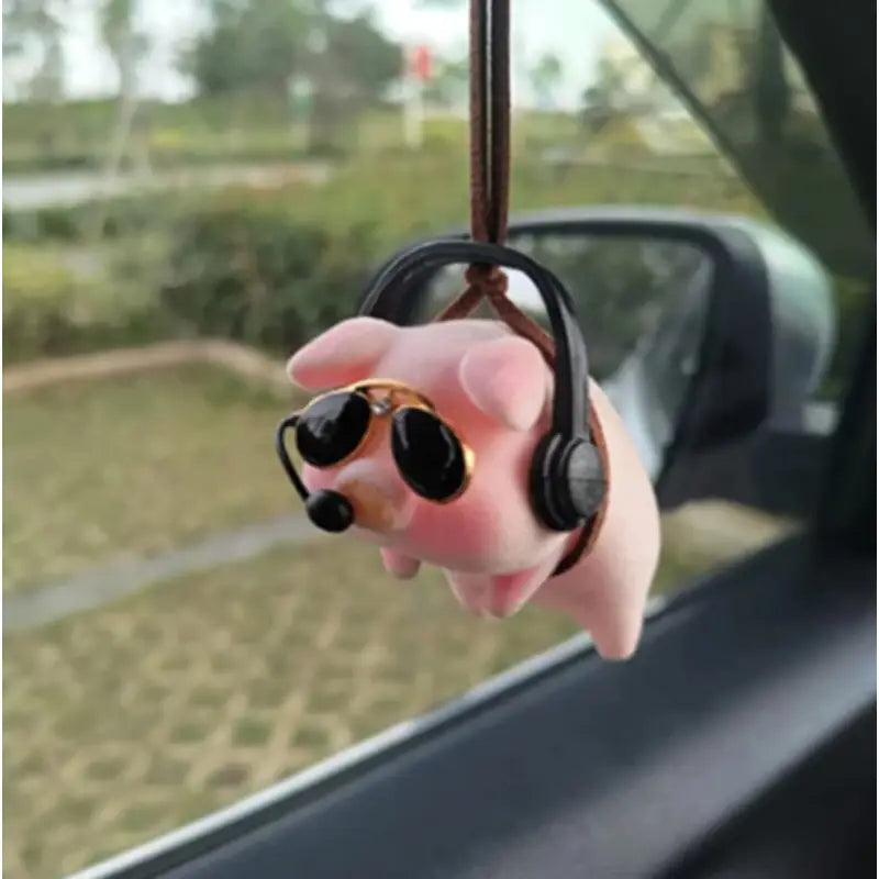 a hand holding a pair of headphones