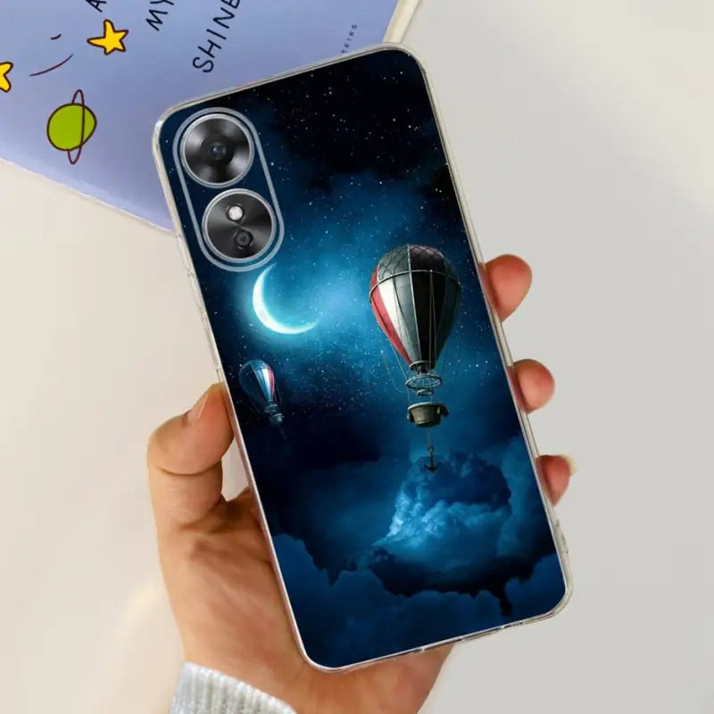 a person holding a phone with a hot air balloon in the sky