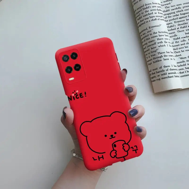 a person holding a red phone case with a bear on it