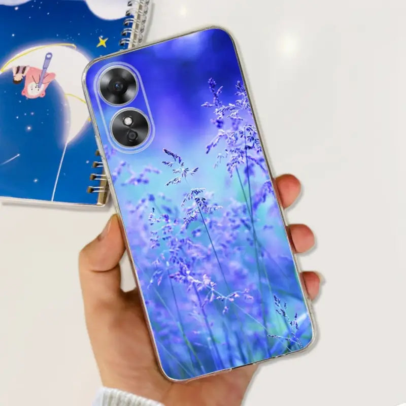 a hand holding a phone case with a blue flower