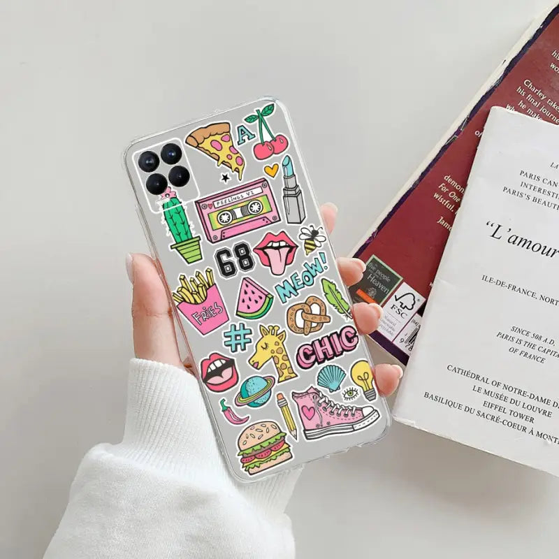 someone holding a phone case with a bunch of stickers on it