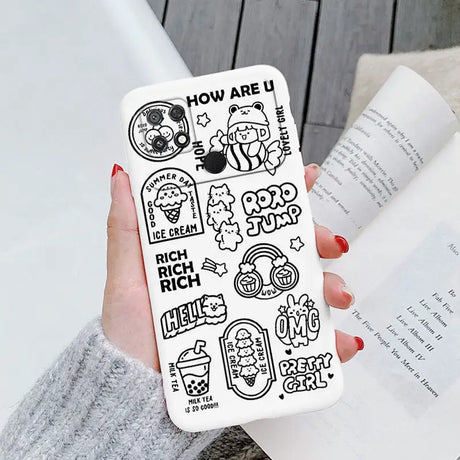 a woman holding a phone case with cartoon drawings on it