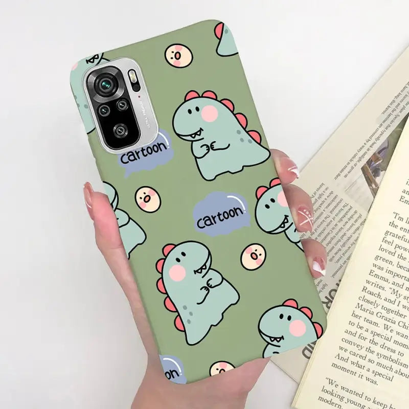 a woman holding a phone case with a pattern of cats