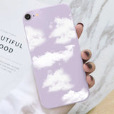 a hand holding a phone case with clouds on it