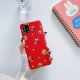someone holding a red phone case with a cookie pattern on it