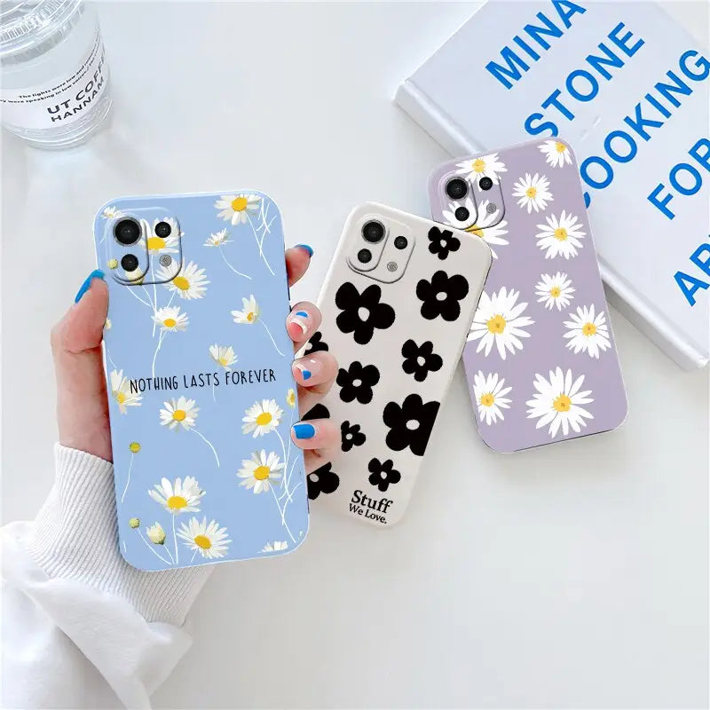 someone holding a phone case with a daisy pattern on it