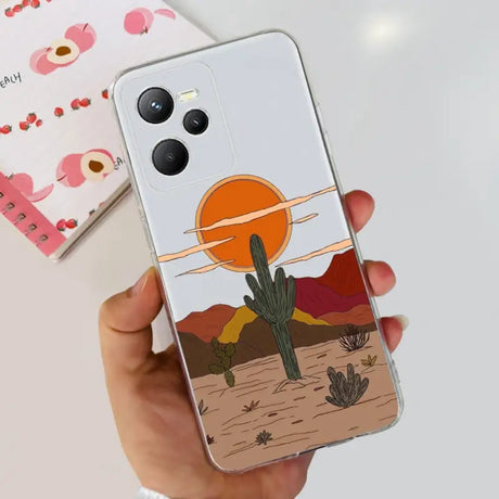 a hand holding a phone case with a desert scene