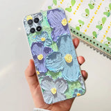 a hand holding a phone case with a floral design
