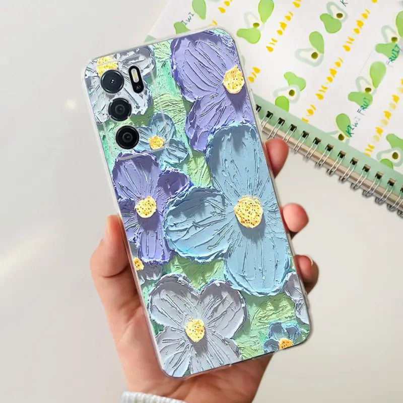 a hand holding a phone case with a floral pattern