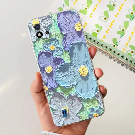 a hand holding a phone case with a floral design