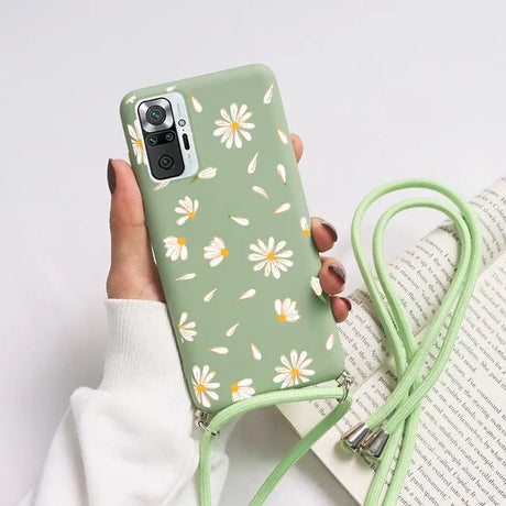 someone holding a phone case with a flower pattern on it