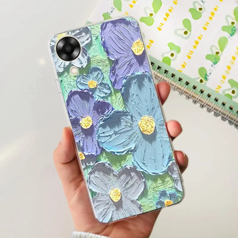 a hand holding a phone case with flowers on it