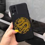a hand holding a phone case with a gold dragon on it