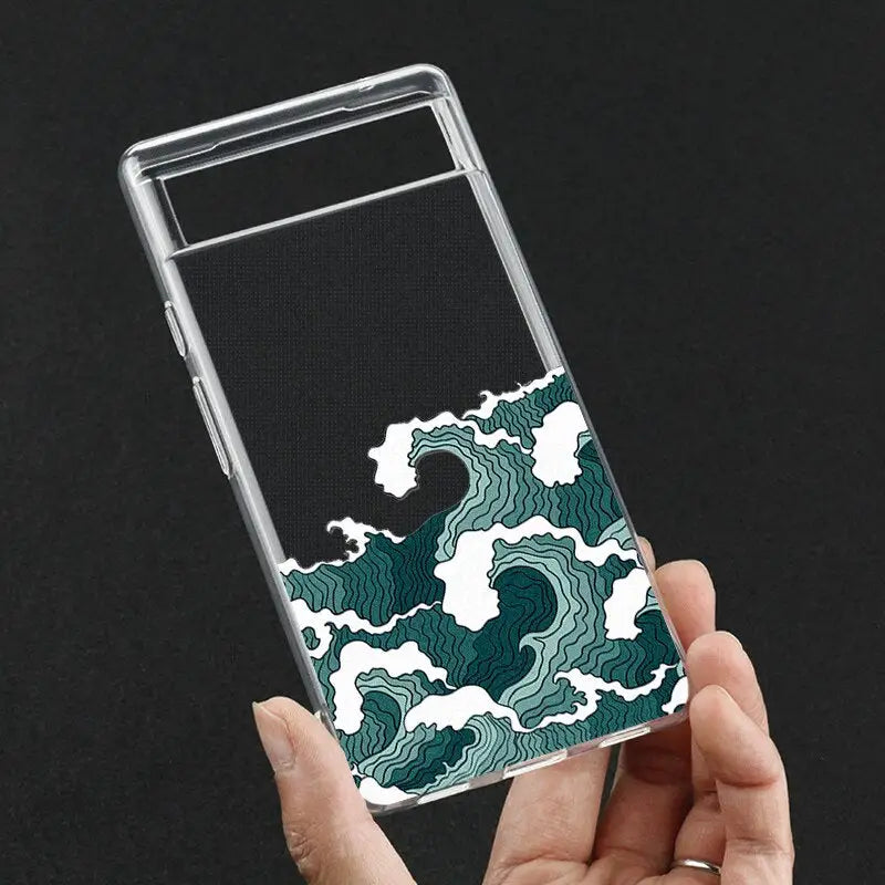 a hand holding a phone case with a green and white pattern