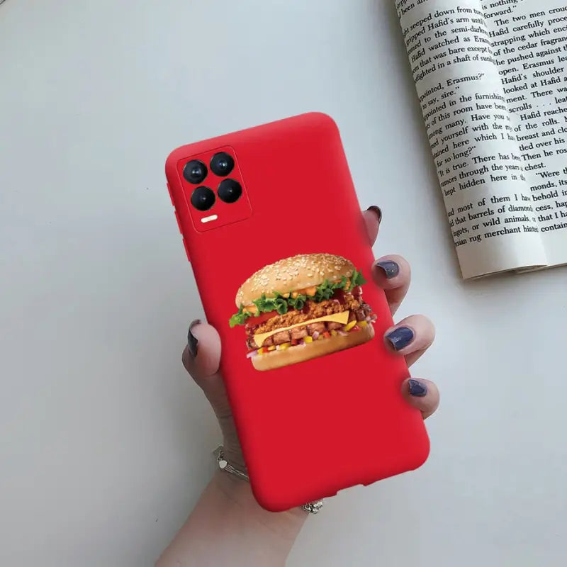 a woman holding a red phone case with a hamburger on it