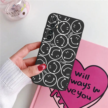 a woman holding a phone case with a heart design