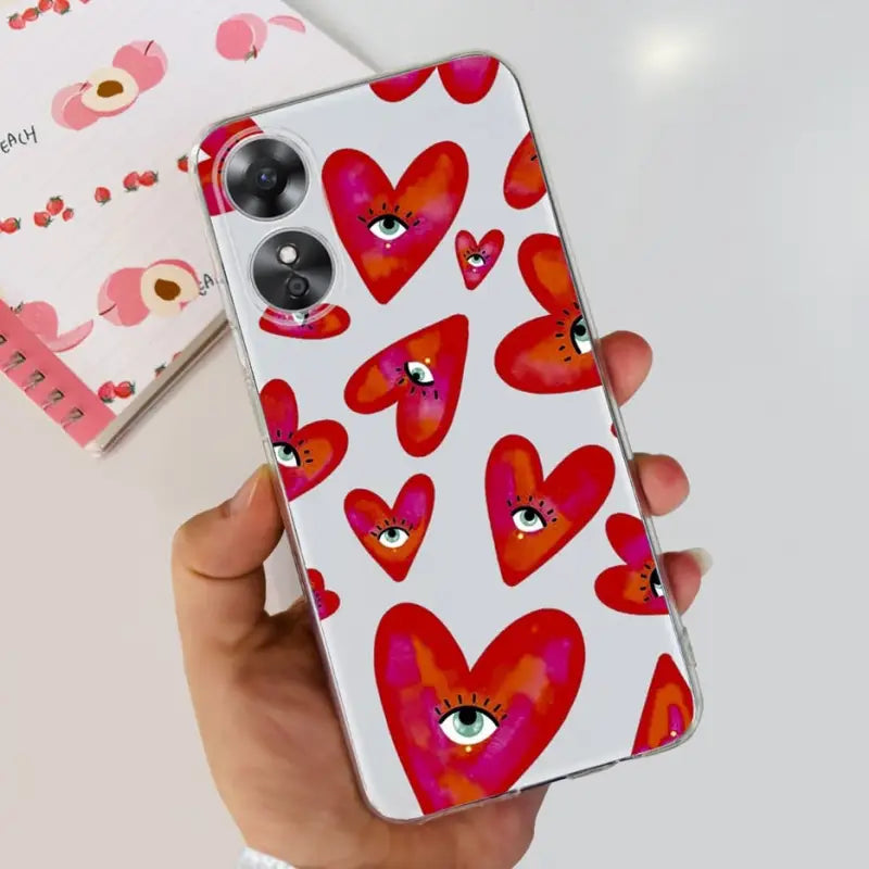 a hand holding a phone case with hearts on it