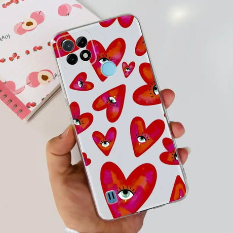 a hand holding a phone case with hearts on it