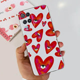 a hand holding a phone case with hearts on it