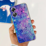 a hand holding a phone case with a purple and blue floral pattern