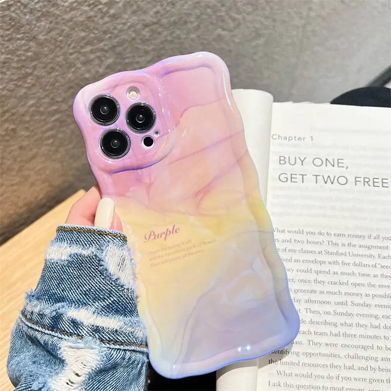 a phone case with a pink and yellow marble pattern