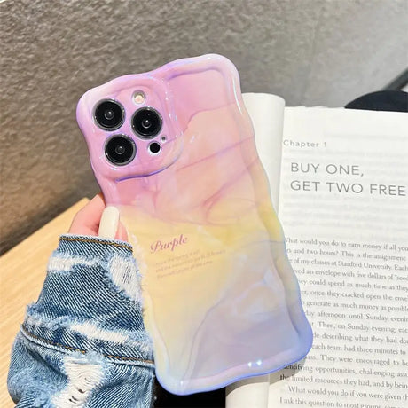 a phone case with a pink and yellow marble pattern