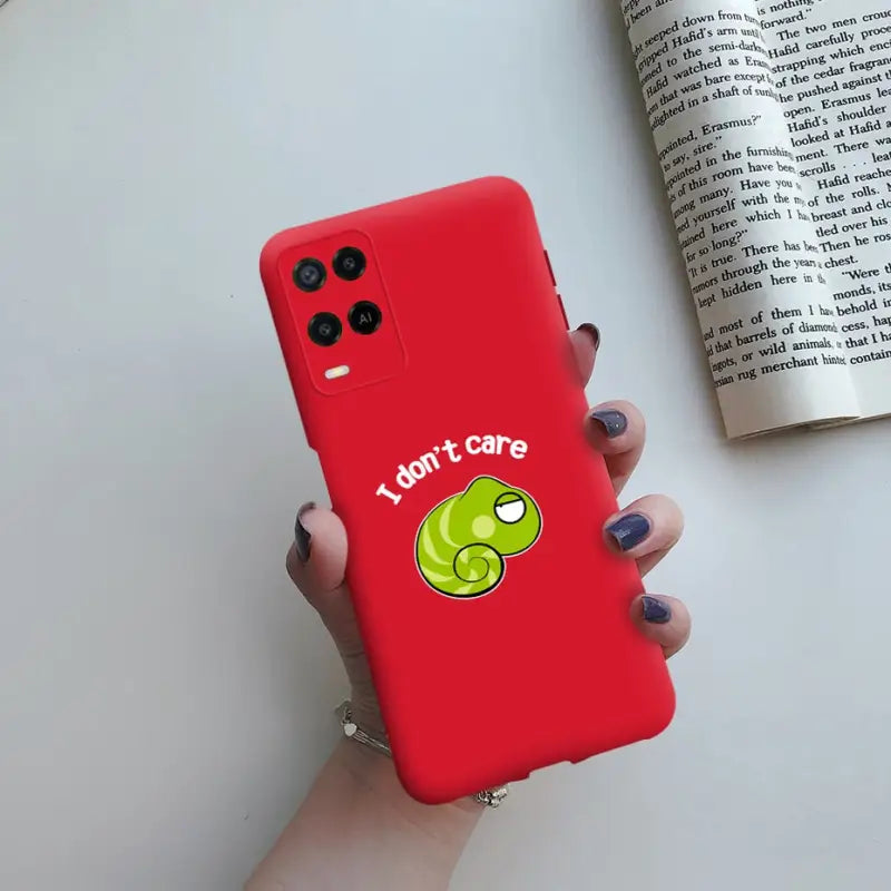 a woman holding a red phone case with a tennis ball on it